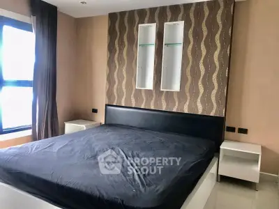 Modern bedroom with stylish wallpaper and large bed in a contemporary apartment.