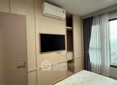 Modern bedroom with built-in wardrobe and air conditioning, featuring a sleek wall-mounted TV.