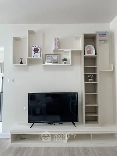 Modern living room with stylish shelving and flat-screen TV, perfect for contemporary home decor.