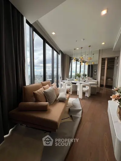 Luxurious high-rise living room with panoramic city views and elegant dining area.