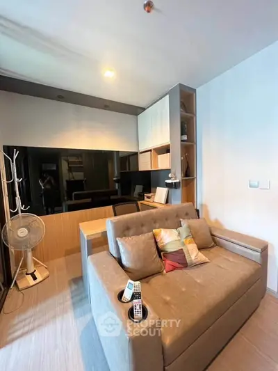 Modern living room with stylish sofa and built-in shelving, perfect for cozy urban living.