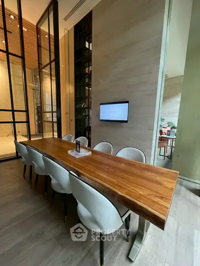 Luxurious modern dining area with elegant wooden table and stylish chairs in a sophisticated setting.