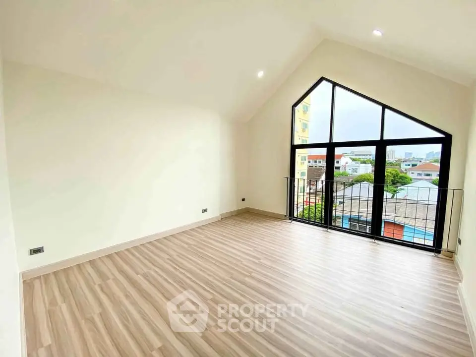 Spacious room with large windows and stunning view, perfect for modern living.