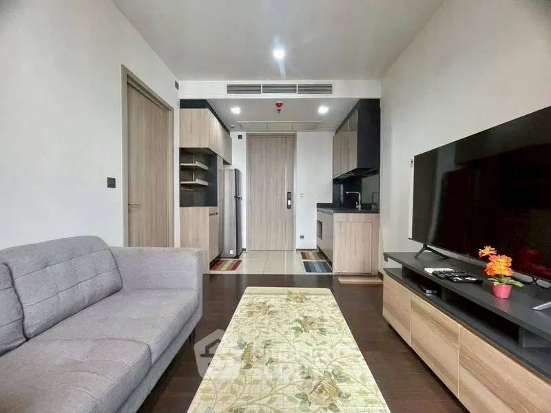 Modern living room with sleek kitchen and stylish decor