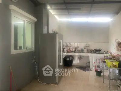 Spacious kitchen with modern appliances and ample natural light, perfect for culinary enthusiasts.