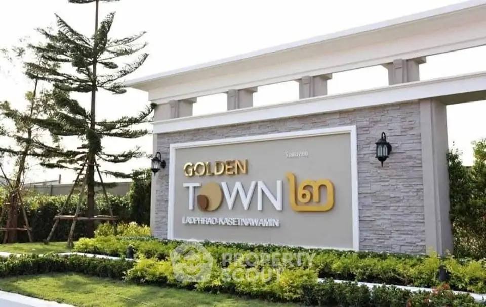 Elegant entrance of Golden Town with lush landscaping and modern design.