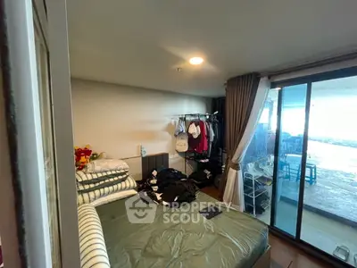 Cozy bedroom with balcony access and ample natural light