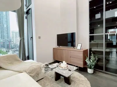 Modern living room with high ceilings and city view, featuring sleek furniture and stylish decor.