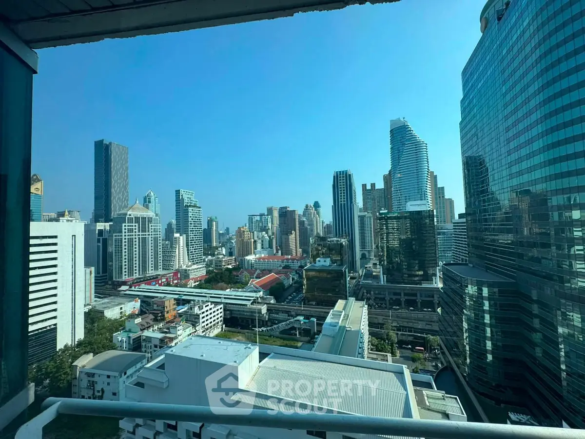 Stunning cityscape view from a high-rise balcony showcasing modern skyscrapers and urban skyline.