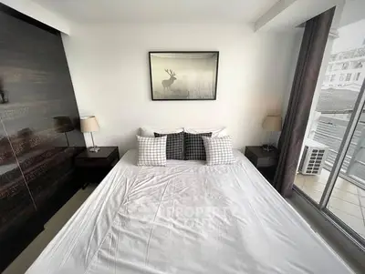 Modern bedroom with stylish decor and balcony access