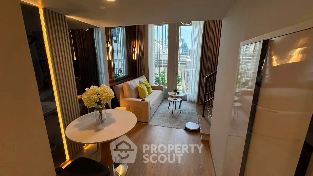 Modern living room with stylish decor and large windows offering city views