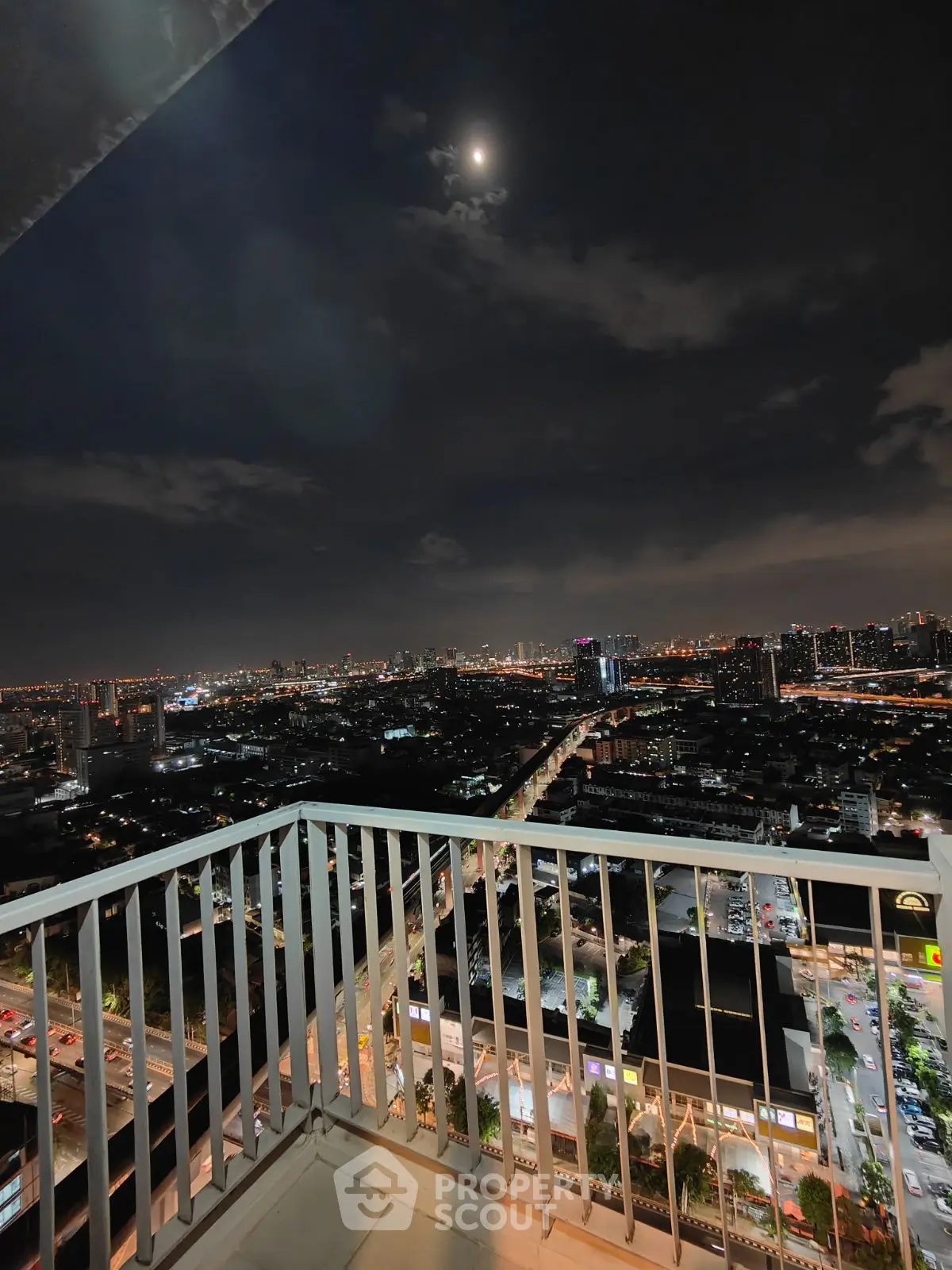 Stunning night cityscape view from a high-rise balcony, perfect for urban living enthusiasts.