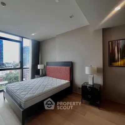 Spacious bedroom with city view and modern decor in luxury apartment