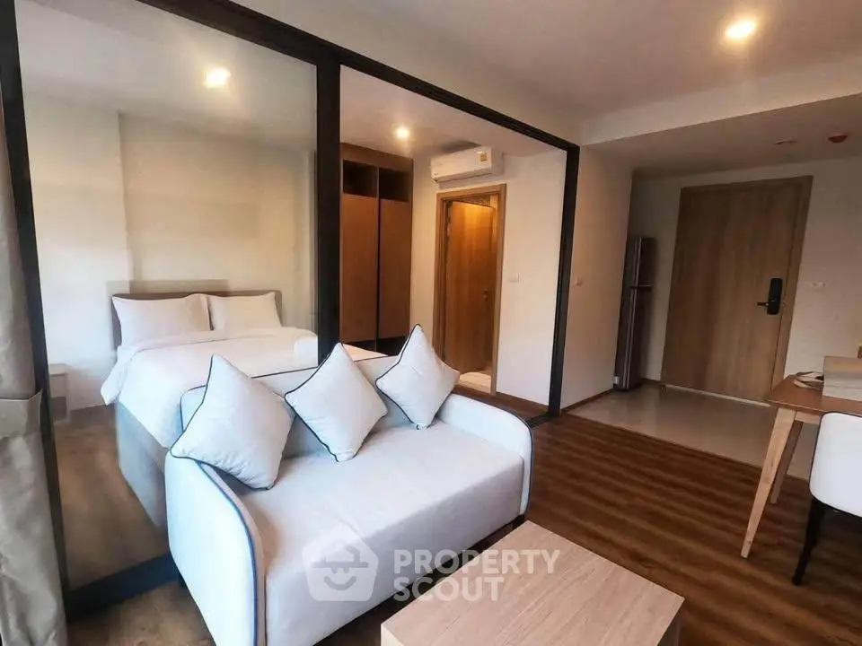 Modern studio apartment with cozy living area and stylish bedroom