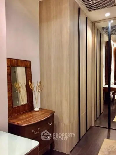 Elegant bedroom with wooden wardrobe and stylish dresser