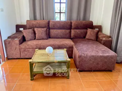 Cozy living room with brown sectional sofa and bamboo coffee table, perfect for relaxation.
