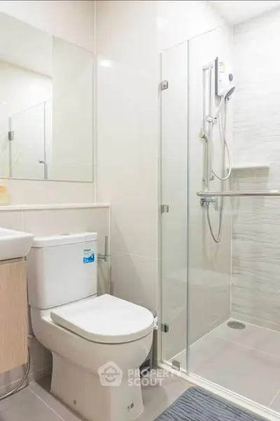 Modern bathroom with glass shower enclosure and sleek fixtures