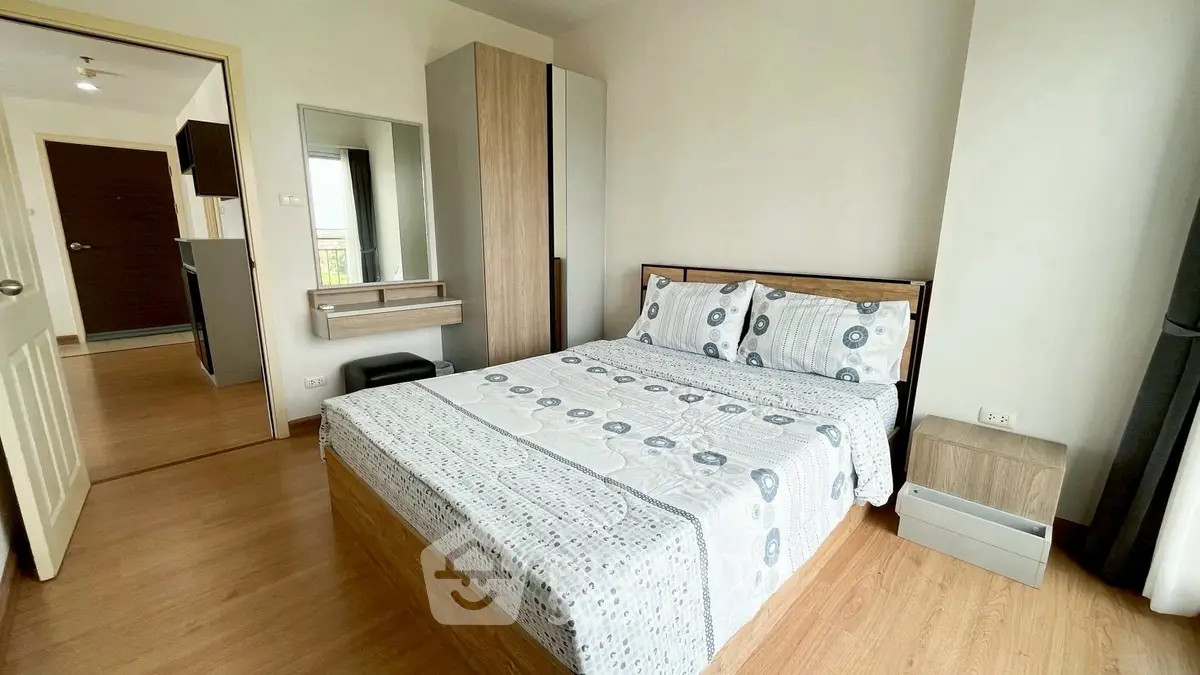 Modern bedroom with stylish decor and wooden flooring in a cozy apartment.