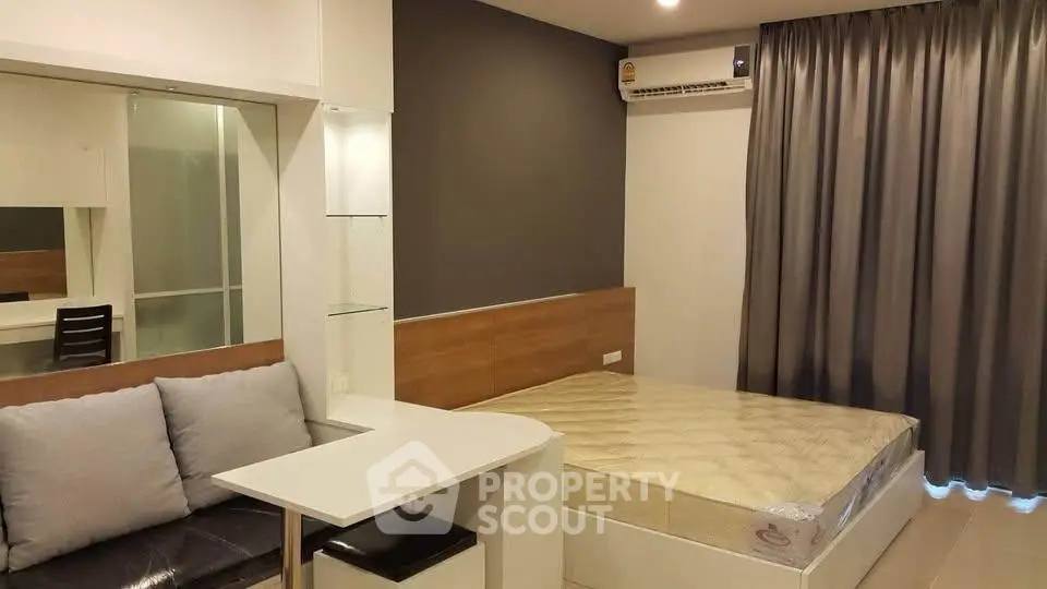 Modern studio apartment with cozy bed and stylish decor