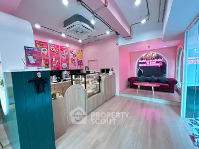 Charming pink-themed cafe interior with cozy seating and modern decor