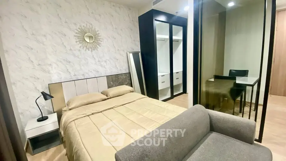 Modern bedroom with stylish decor and mirrored wardrobe