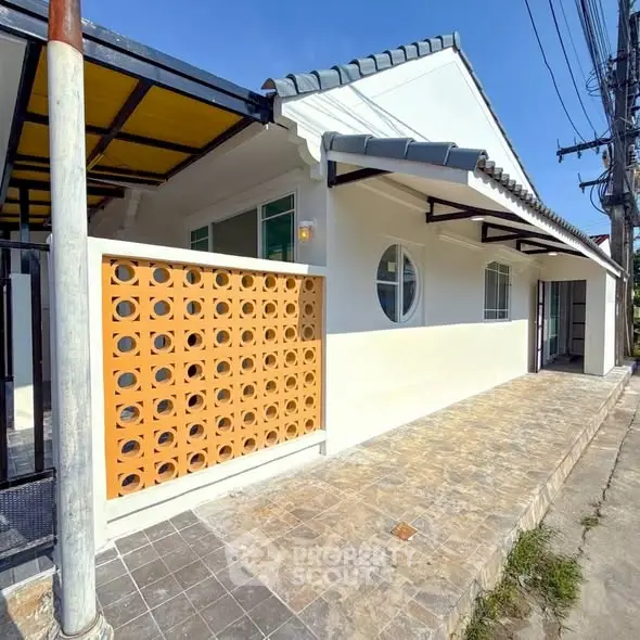 Charming single-story home with unique circular window and modern facade