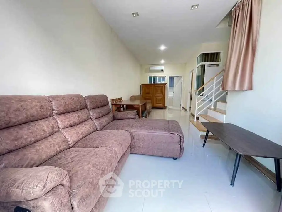 Spacious living room with cozy brown sectional sofa and modern decor
