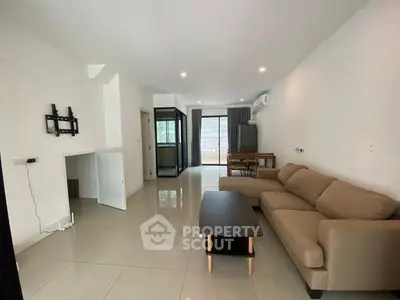 Spacious living room with modern sofa and sleek tile flooring