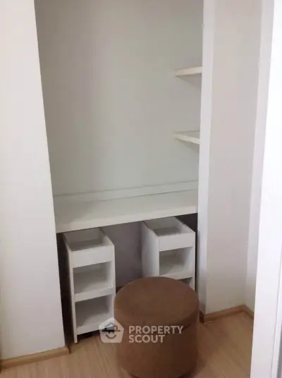 Cozy study nook with built-in desk and shelves, perfect for a compact home office setup.