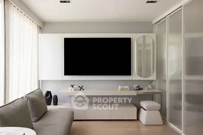 Modern living room with sleek furniture and large TV, perfect for stylish urban living.