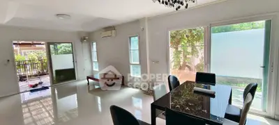 Spacious living room with modern dining area and large windows