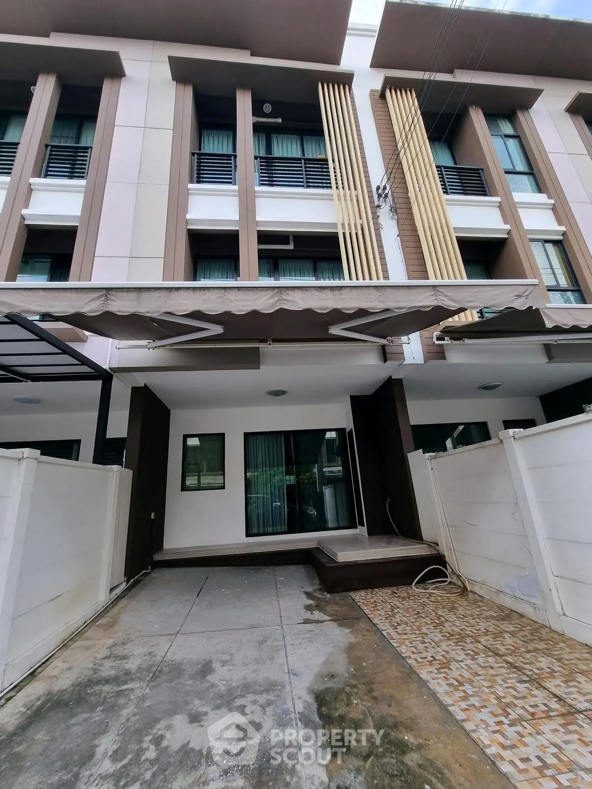 Modern townhouse exterior with sleek design and spacious driveway
