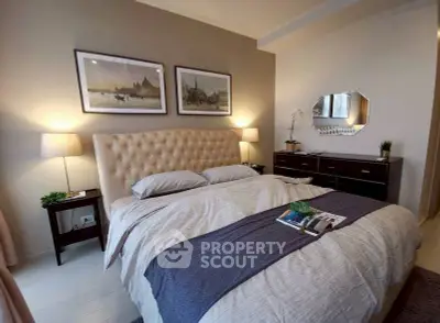 Elegant bedroom with plush headboard and stylish decor, perfect for relaxation and comfort.