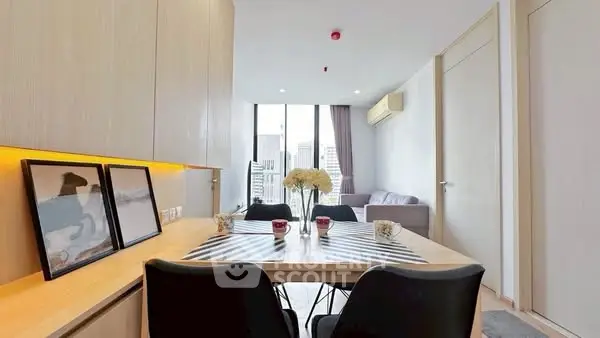 Modern living room with city view, stylish decor, and cozy seating area.