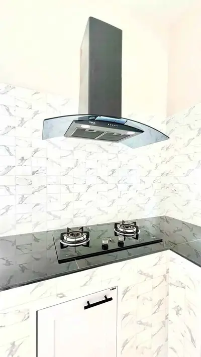 Modern kitchen with sleek gas stove and stylish backsplash tiles