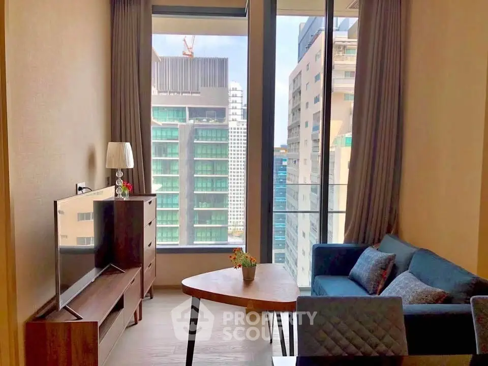 Modern living room with city view, featuring stylish furniture and large windows for natural light.