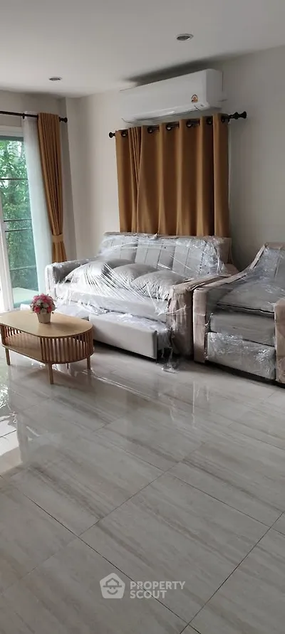 Spacious living room with modern furniture and large windows for natural light.