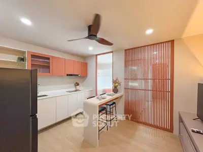 Modern kitchen with sleek design, featuring open layout and stylish cabinetry.