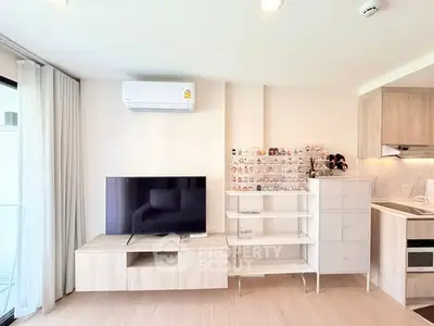 Modern living room with TV, air conditioning, and stylish shelving in a bright apartment.