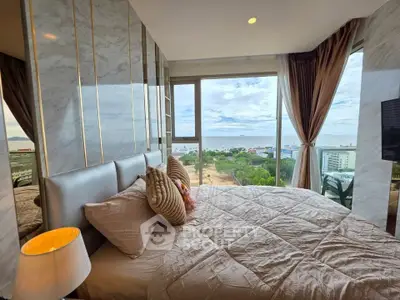 Luxurious bedroom with stunning ocean view and elegant decor in high-rise apartment.