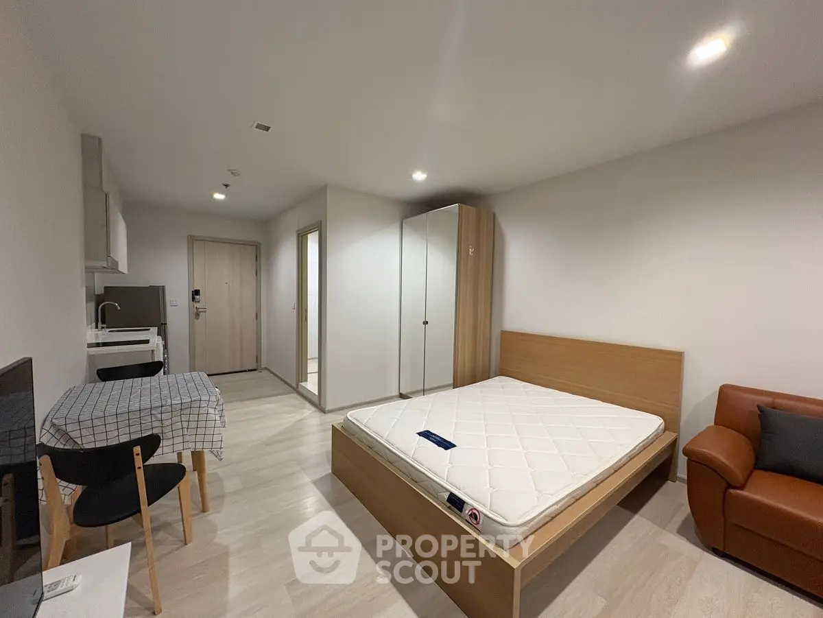 Modern studio apartment with minimalist design and cozy furnishings.