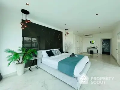 Spacious master bedroom with modern design, sleek furnishings, and integrated living space, featuring a luxurious en-suite and marble flooring.