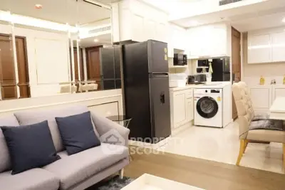 Modern open-layout kitchen and living room with sleek appliances and stylish decor.