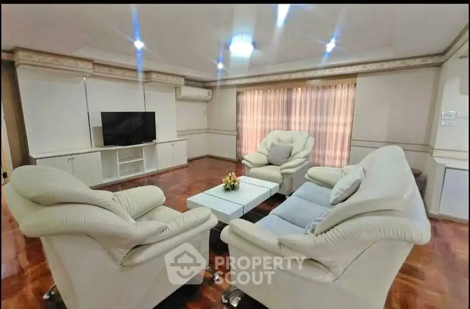 Spacious living room with plush white sofas and modern decor