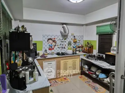 Charming kitchen with unique decor and ample counter space, featuring a gas stove and cozy atmosphere.