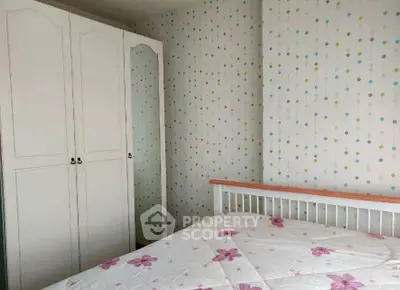 Charming bedroom with floral bedding and stylish wardrobe in cozy apartment.