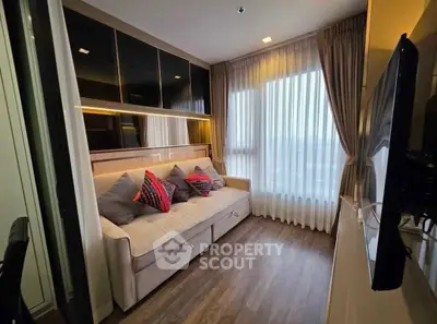 Modern living room with cozy sofa and large window offering natural light
