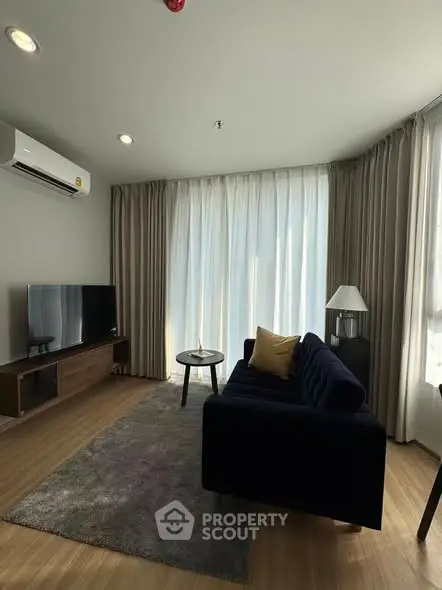 Modern living room with stylish furniture and large windows for natural light.