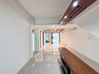 Spacious modern living room with sleek design and large windows for natural light.