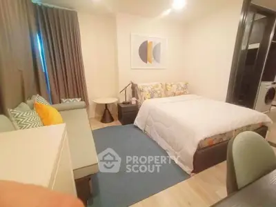 Cozy bedroom with modern decor and comfortable seating area in a stylish apartment.